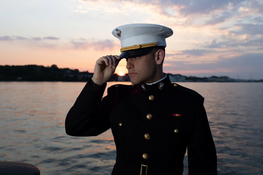 Midshipmen Portrait at USNA near water with sunrise in background.