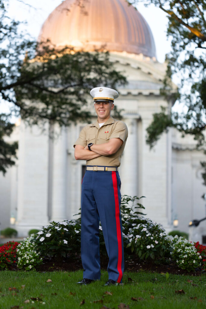 Marine Corps officer in blood stripe pants at Naval Academy Chapel dome.