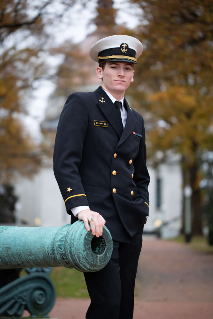 USNA senior portrait in dress blues at Mexican monument canon.